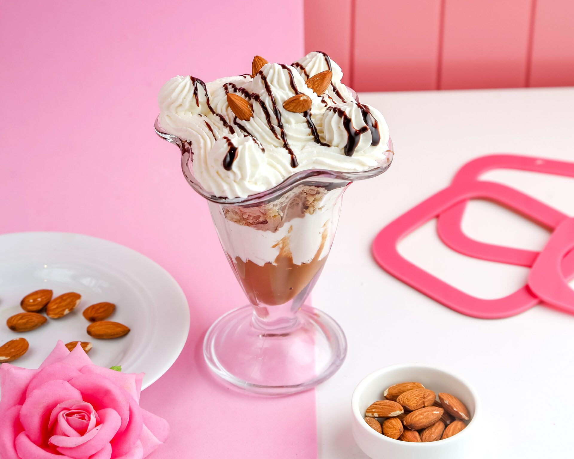 side view almond parfait with caramel yogurt crumbled cookies whipped cream and almond